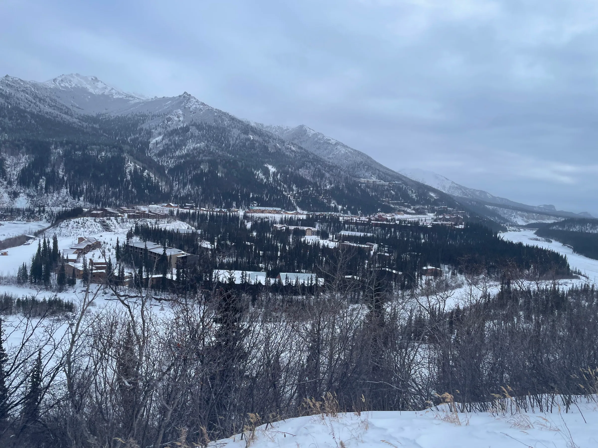 列车窗外开阔的雪山谷地